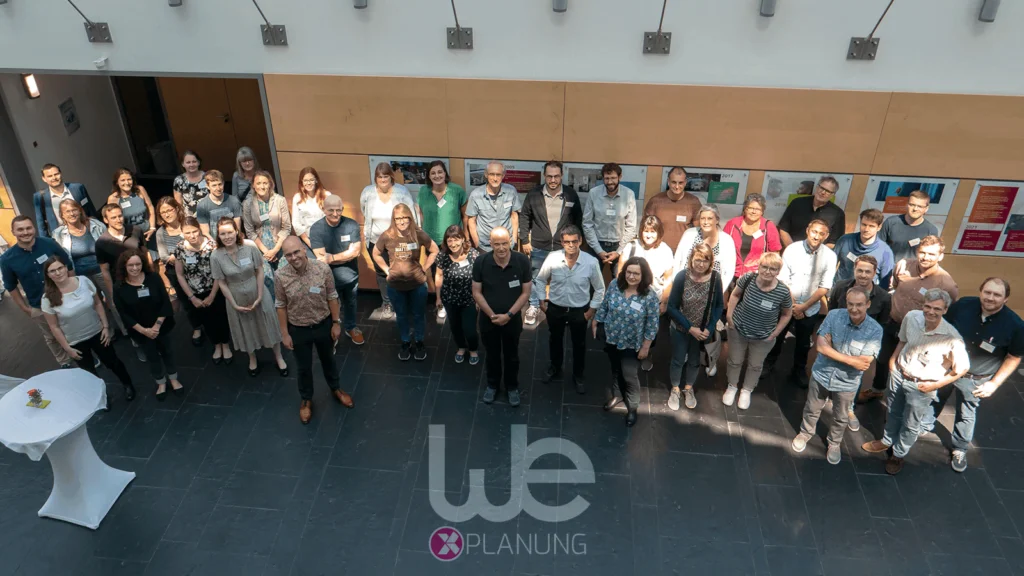 group shot of the attendants of wetransform's 2022 XPlanung user forum with wetransform XPlanung logo superimposed in front