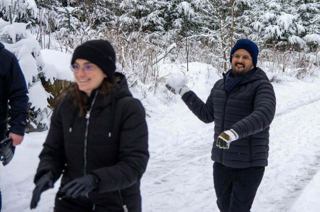 Back-end guy Kapil throws snow towards UI engineer Livia