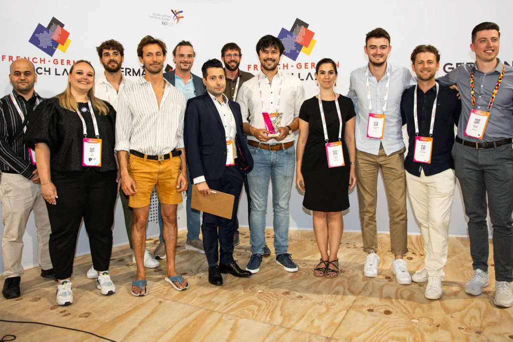 A group of Viva Technology 2023 presenters pose for a group picture on the German-French convention stage