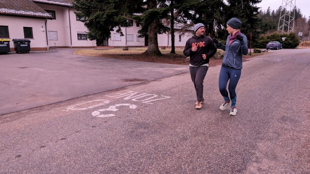 Kapil and Anna chat as they jog along a road in Saig.