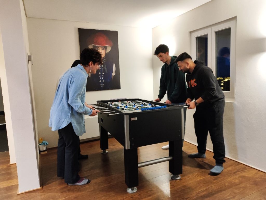 Four members of the wetransform team play foosball together