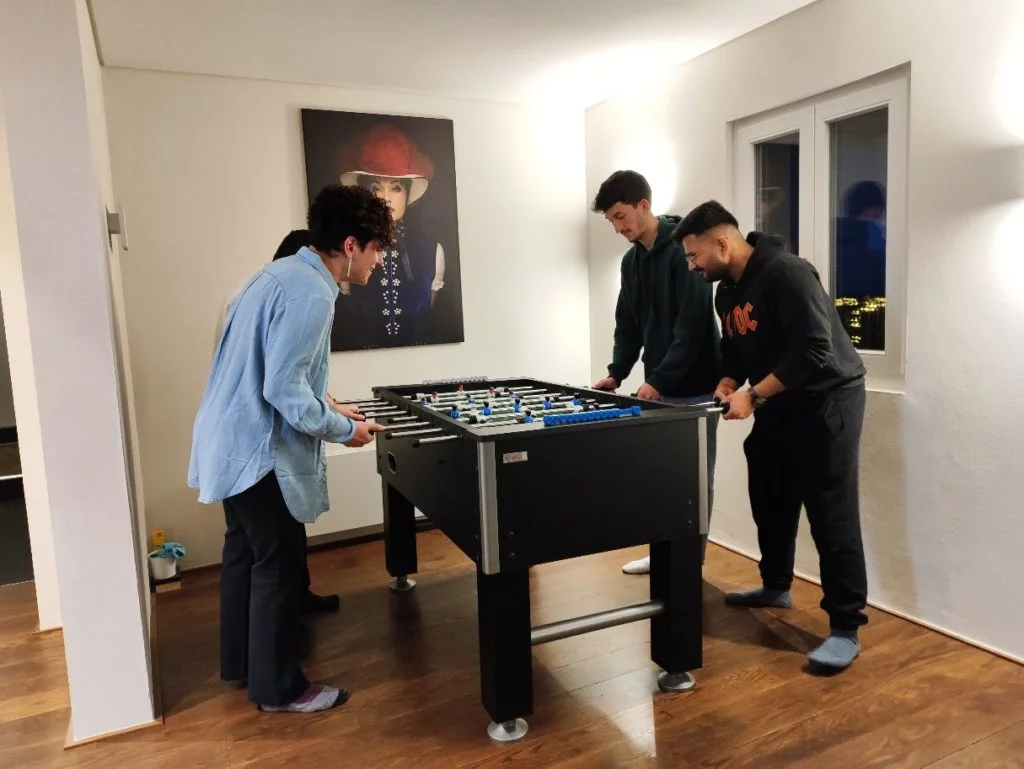 Four members of the wetransform team play foosball together