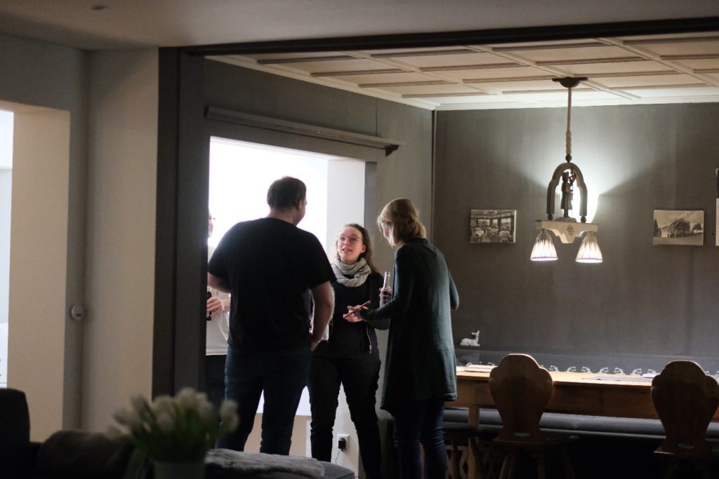 four members of the wetransform team having an animated discussion.