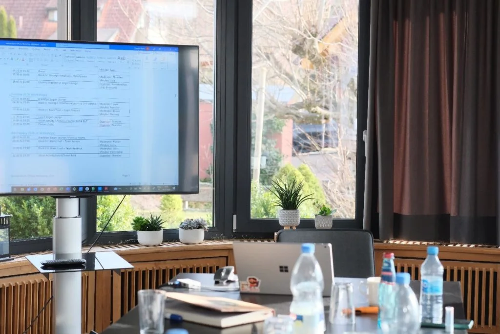 A partial view of the conference table and presentation screen at wetransform's 2024 offsite.