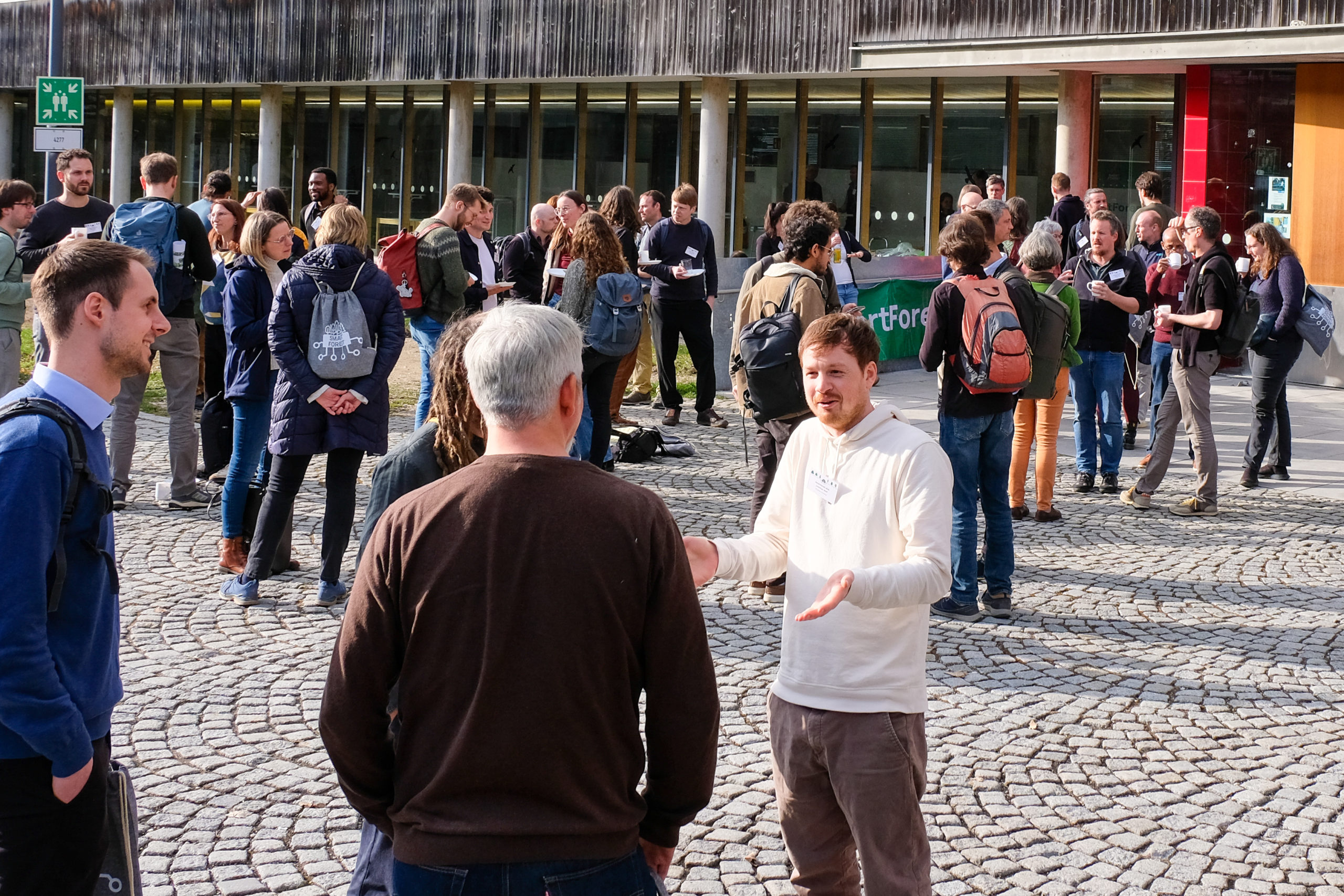 SmartForest 2026 attendees gathered outside the venue, chatting in small groups
